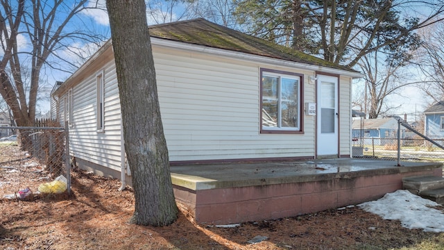 view of outbuilding featuring fence