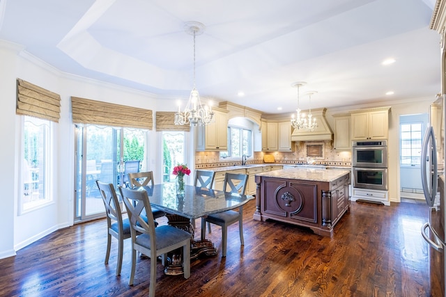 dining space featuring dark wood-style flooring, a notable chandelier, and crown molding