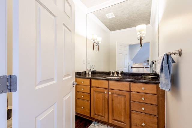 bathroom with ornamental molding, visible vents, vanity, and wood finished floors