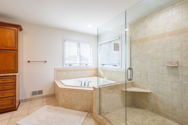 full bathroom with a garden tub, visible vents, a stall shower, tile patterned flooring, and baseboards