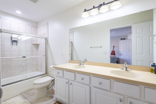 ensuite bathroom with connected bathroom, tile patterned flooring, a sink, and double vanity