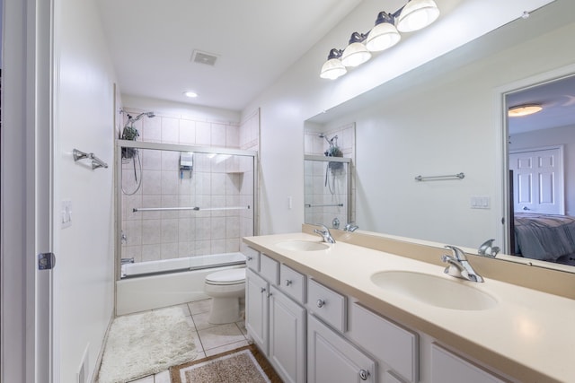 ensuite bathroom with visible vents, ensuite bathroom, a sink, and tile patterned floors