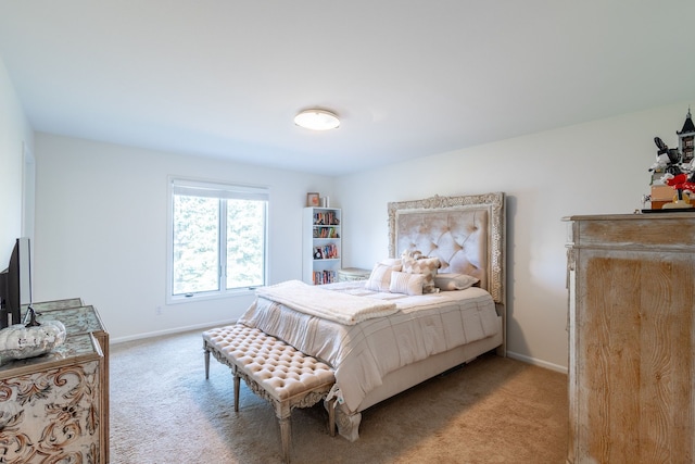 bedroom featuring light carpet and baseboards