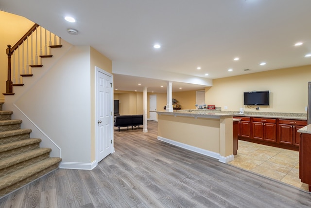 kitchen featuring recessed lighting, a center island, and light wood-style floors