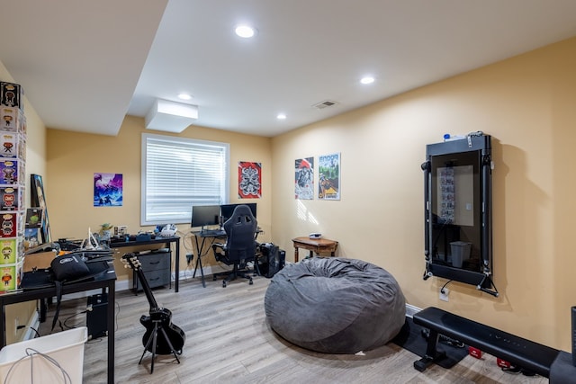 office space with recessed lighting, visible vents, baseboards, and wood finished floors