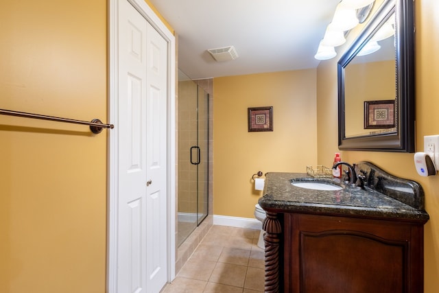 full bathroom with a stall shower, baseboards, toilet, tile patterned flooring, and vanity