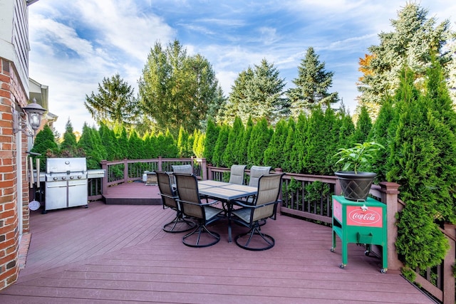 deck featuring a grill and outdoor dining area