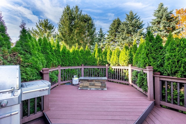 wooden deck featuring a fire pit