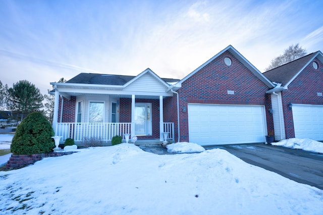 ranch-style house with covered porch, brick siding, and a garage