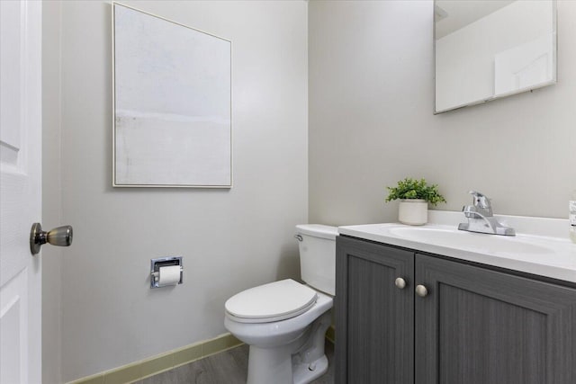 bathroom featuring toilet and vanity