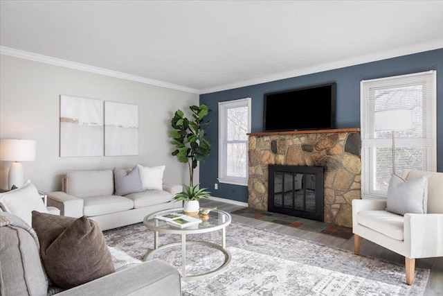 living area featuring baseboards, a stone fireplace, wood finished floors, and crown molding