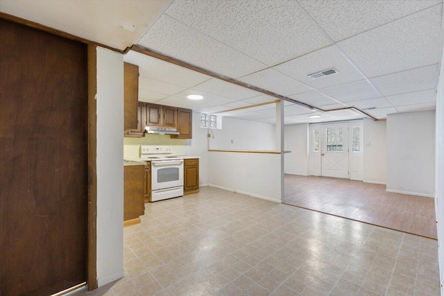 kitchen featuring visible vents, brown cabinetry, light floors, white electric range, and under cabinet range hood