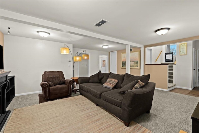 living room with carpet, visible vents, baseboards, and stairs