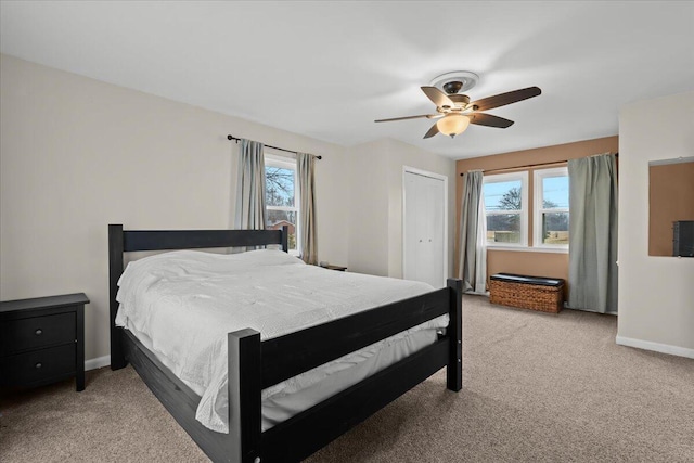 bedroom with light carpet, ceiling fan, and baseboards