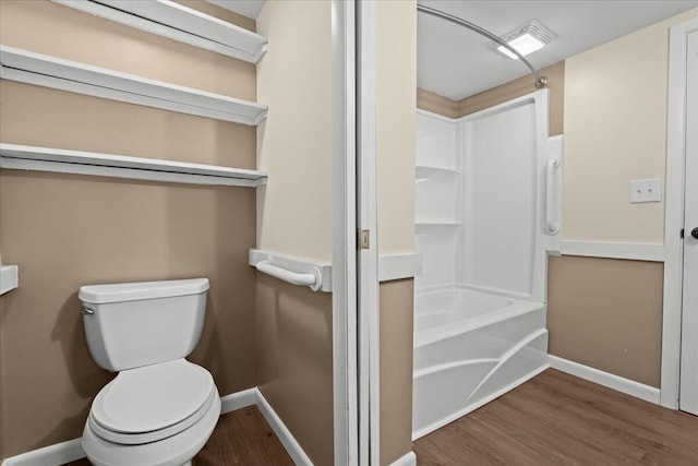 full bathroom featuring shower / tub combination, toilet, wood finished floors, visible vents, and baseboards