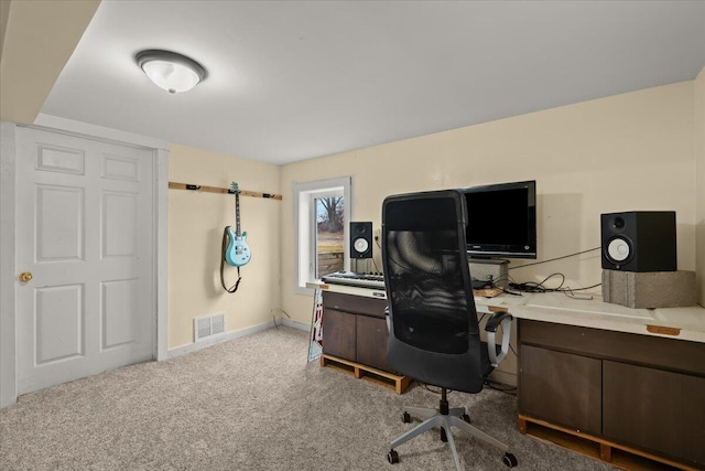 office space with light colored carpet, visible vents, and baseboards