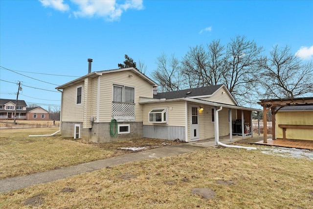 back of house featuring a yard and a patio area