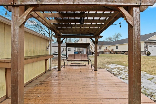 wooden deck featuring a lawn