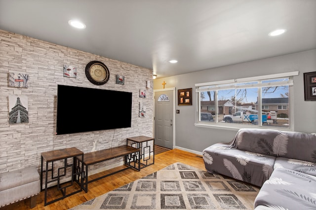 living room with baseboards, wood finished floors, and recessed lighting