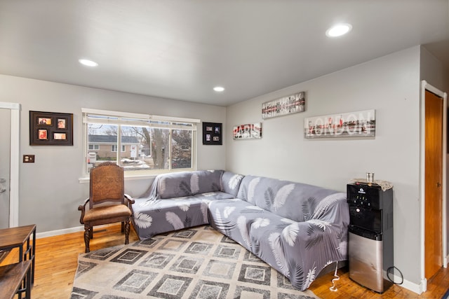 living room with recessed lighting, baseboards, and wood finished floors