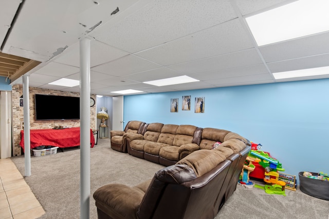 living area featuring carpet floors and a paneled ceiling