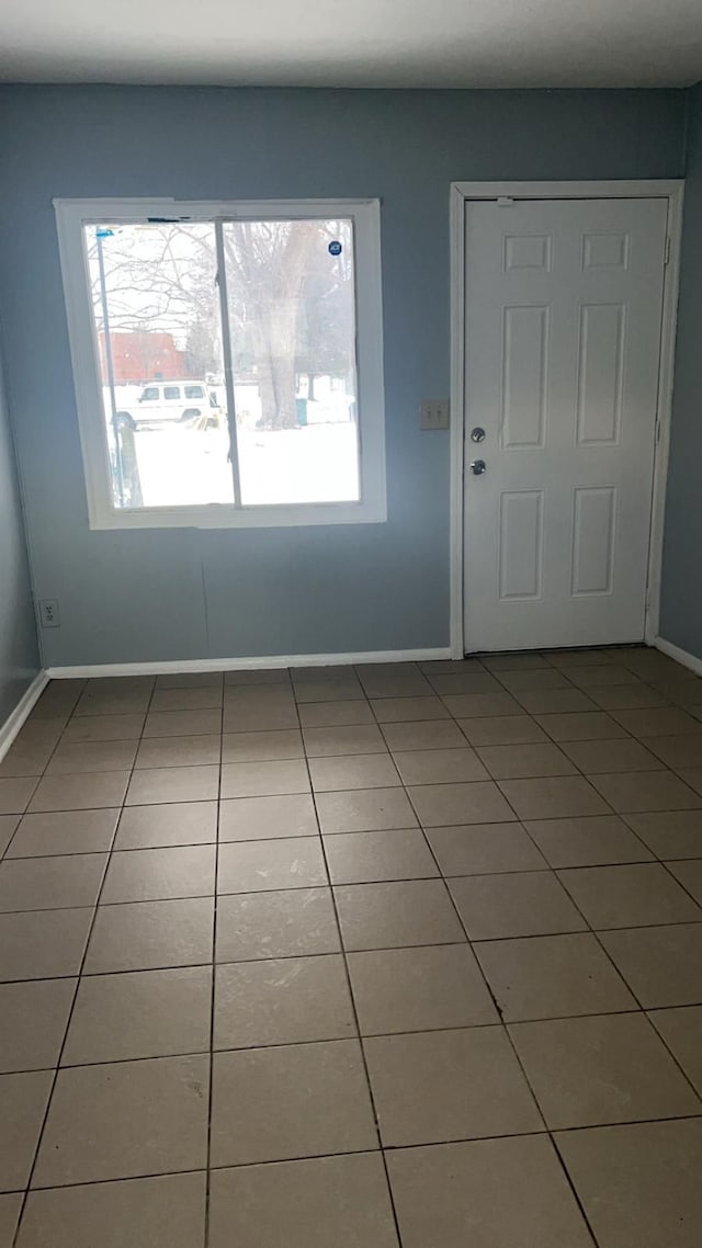 tiled entrance foyer with baseboards