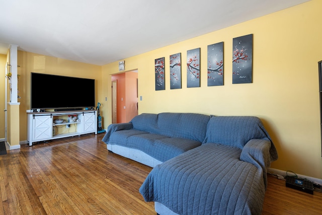 living room featuring baseboards and wood finished floors