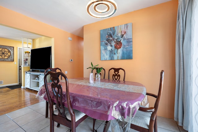 dining space with tile patterned flooring and baseboards