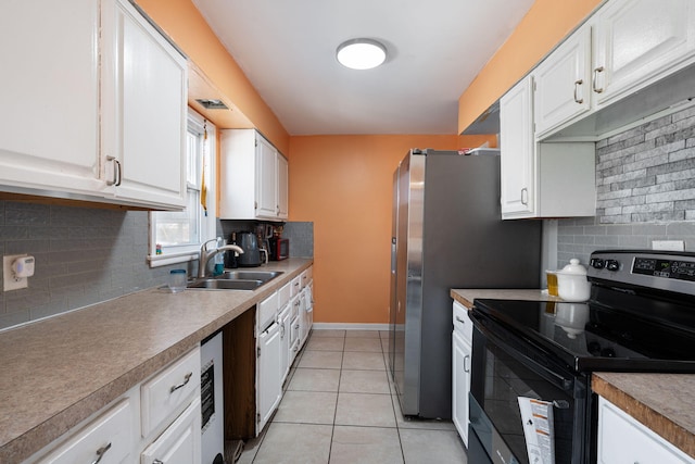 kitchen featuring electric range, white cabinets, light tile patterned flooring, a sink, and baseboards