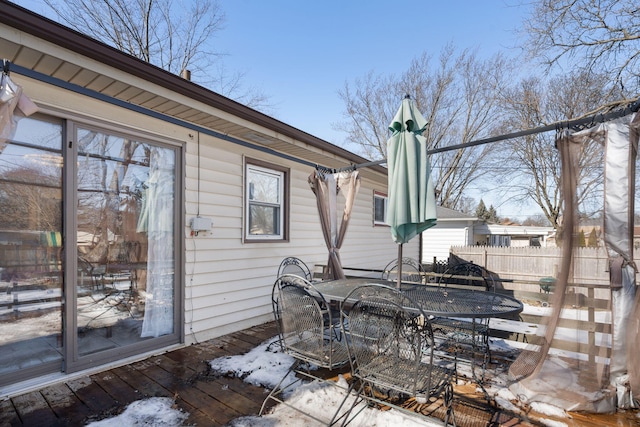 exterior space with a chimney, fence, and outdoor dining area