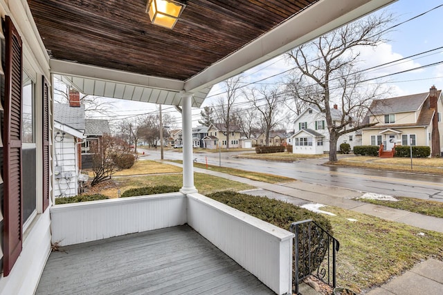 exterior space with covered porch and a residential view