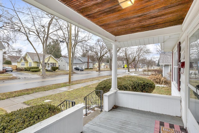 exterior space featuring covered porch and a residential view