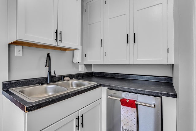 kitchen featuring a sink, dark countertops, white cabinets, and stainless steel dishwasher