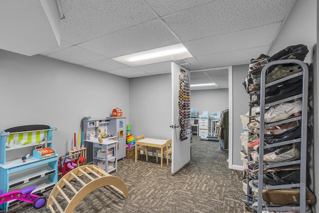 rec room featuring carpet floors and a paneled ceiling