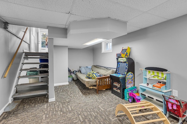 bedroom with carpet floors, a drop ceiling, and baseboards