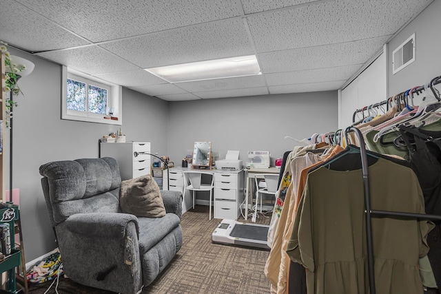 spacious closet featuring carpet floors, visible vents, and a drop ceiling