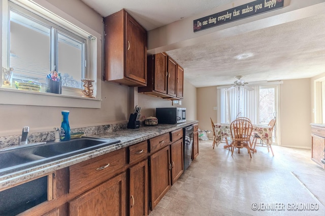 kitchen featuring light floors, stainless steel microwave, brown cabinetry, and a ceiling fan