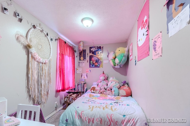 bedroom featuring carpet and a textured ceiling