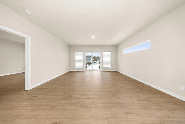 empty room featuring light wood-style flooring and baseboards