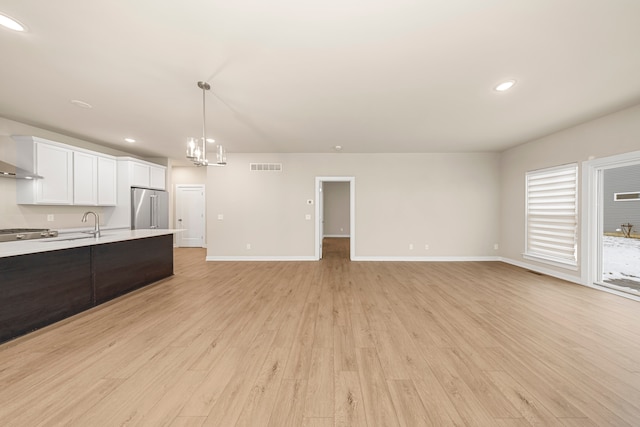 kitchen featuring visible vents, light wood-style floors, white cabinetry, high end fridge, and light countertops