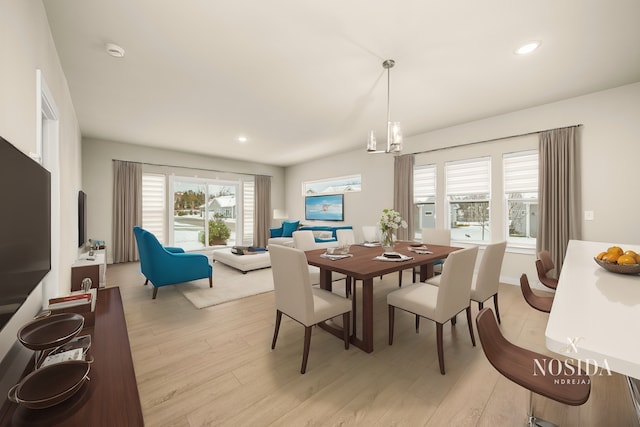 dining area featuring recessed lighting, plenty of natural light, light wood-style flooring, and a notable chandelier