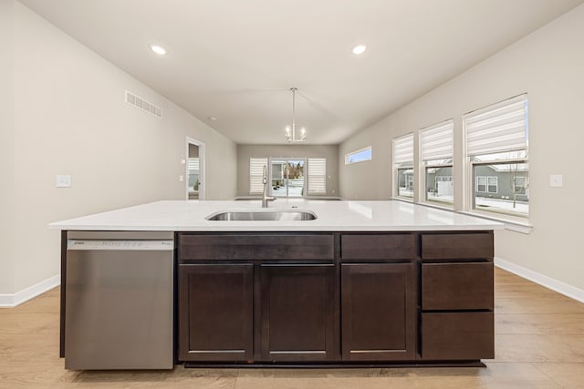 kitchen with light countertops, visible vents, stainless steel dishwasher, dark brown cabinetry, and a sink