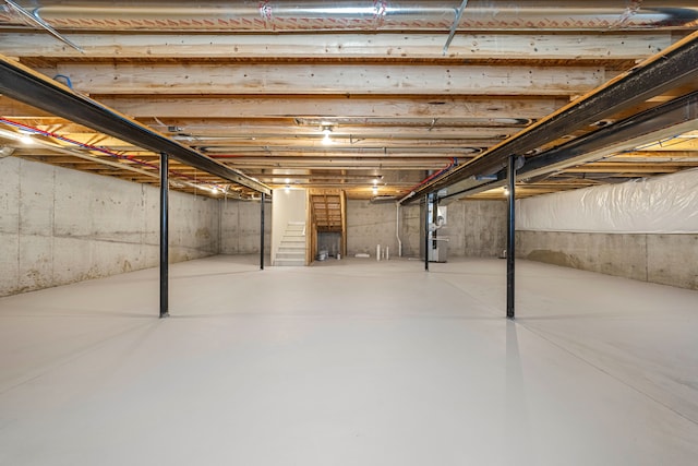 unfinished basement featuring heating unit