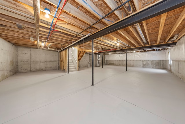 unfinished basement featuring stairway