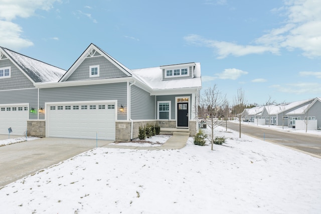 view of front of house with stone siding and concrete driveway