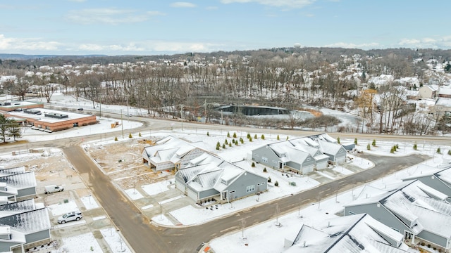 snowy aerial view with a residential view