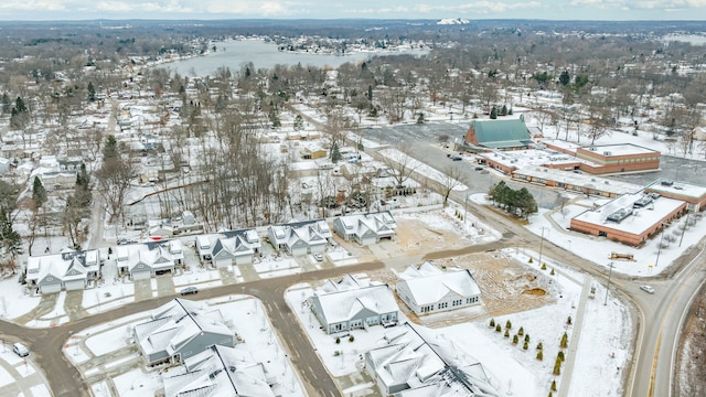 snowy aerial view with a residential view