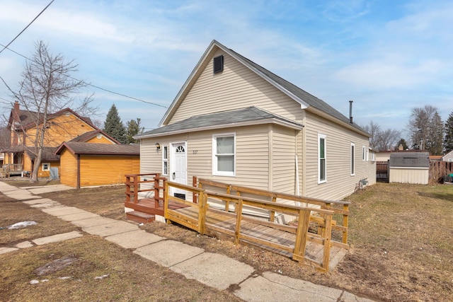 exterior space featuring an outdoor structure, a wooden deck, and a shed