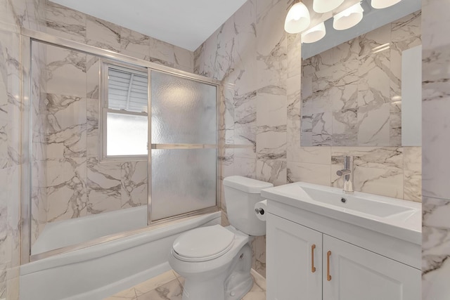 bathroom featuring marble finish floor, enclosed tub / shower combo, toilet, and stone wall