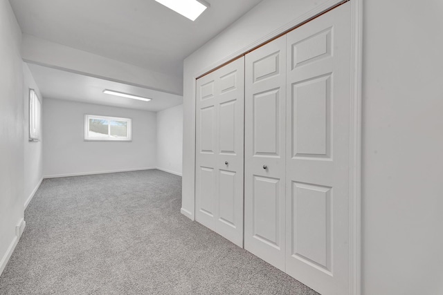 below grade area with carpet floors and baseboards